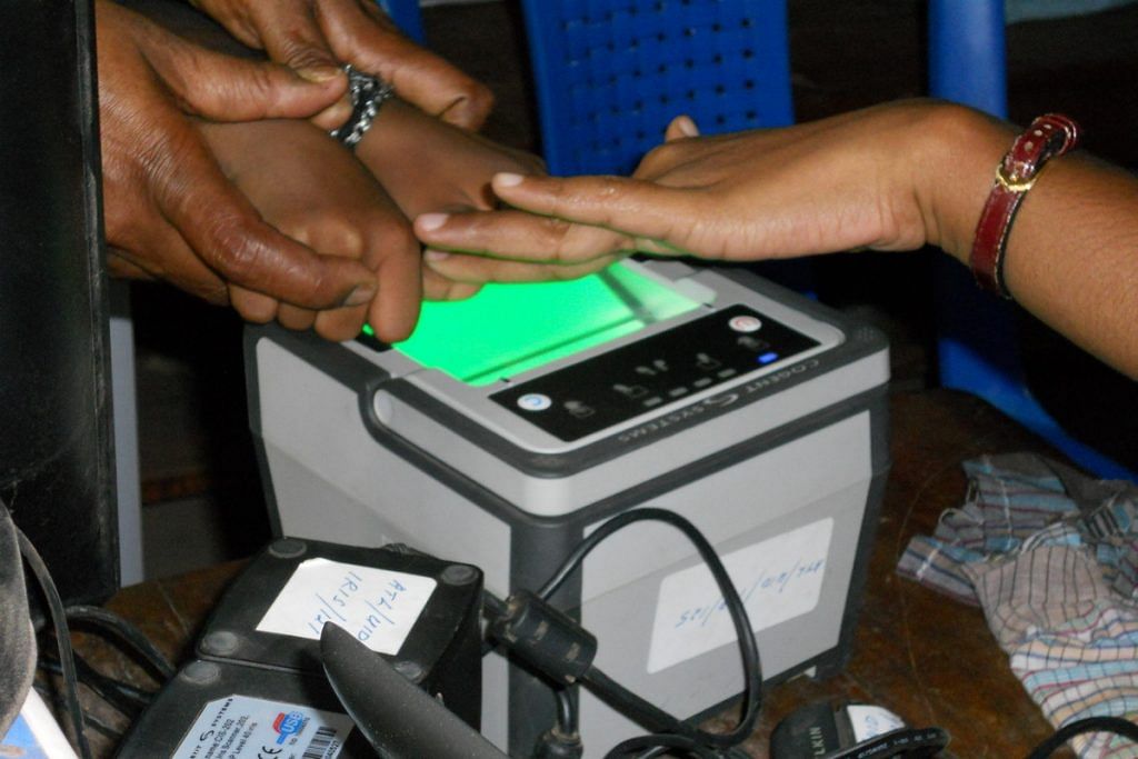 An individual records fingerprints as part of the biometric data collection for Aadhaar | Commons