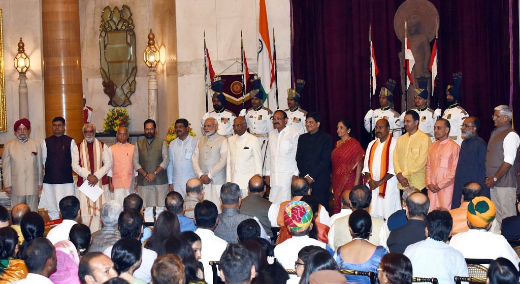 The newly sworn in ministers of the government stand with the Prime Minister, President and Vice President