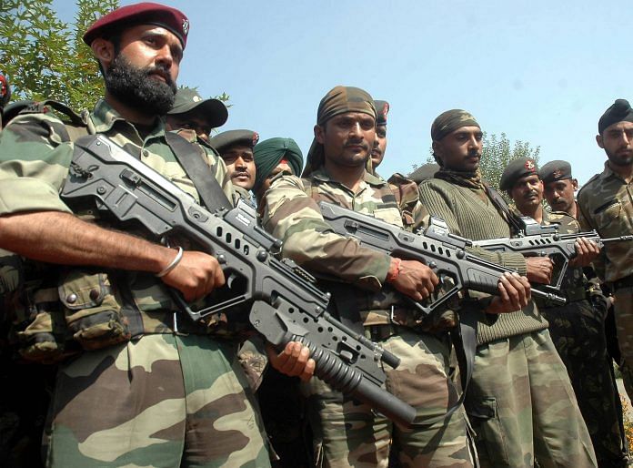 Indian soldiers standing, holding guns