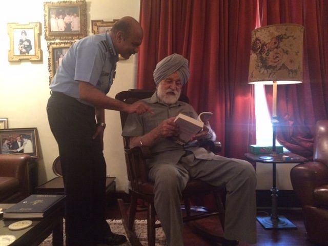 Marshal of the Indian Air Force Arjan Singh reads the author's book on the history of the IAF