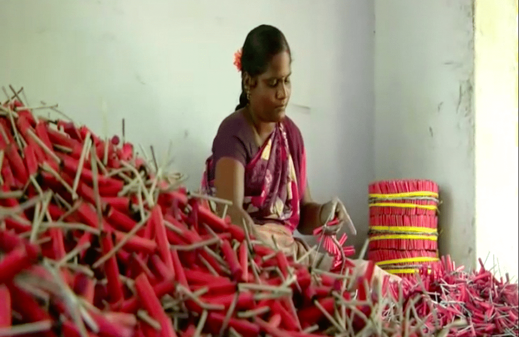 An employee of a fireworks factory in Sivakasi making fireworks