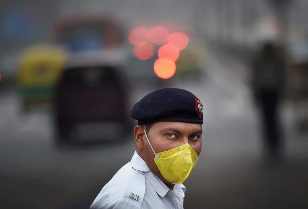 A traffic policeman wearing a mask in Delhi. The smog in Delhi is being blamed on stubble burning in Punjab and Haryana