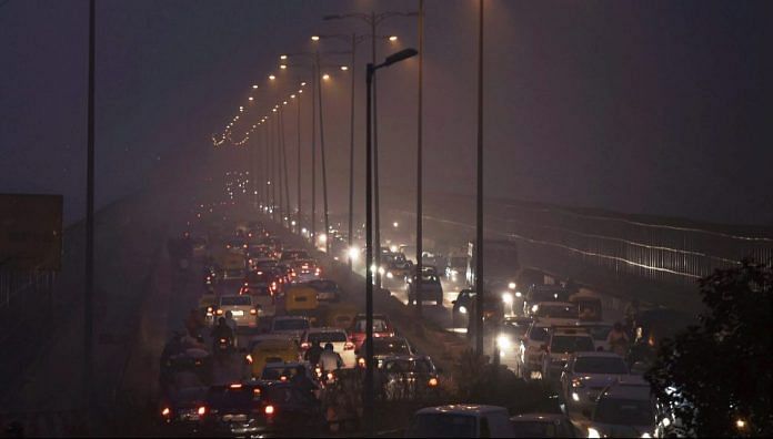 Cars in traffic in smog