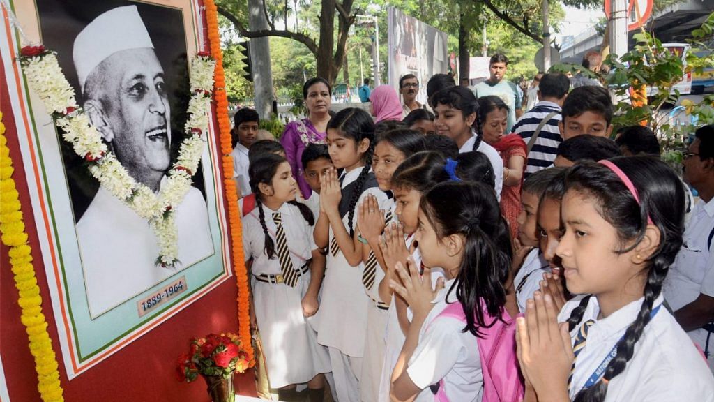 School children infront of Nehru's framed image
