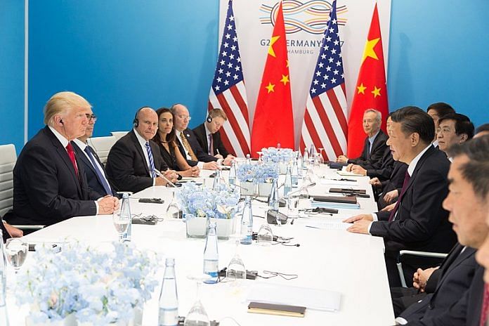 Trump and Jinping at a press conference table at the G20