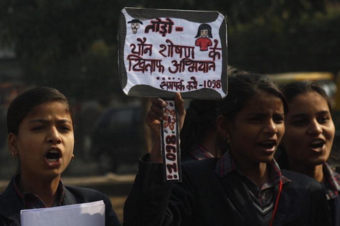 School children holding placards and shouting slogans during an awareness rally against the sexual violence against women & children