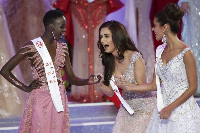 India's Manushi Chhillar (centre) reacts as she is declared Miss World