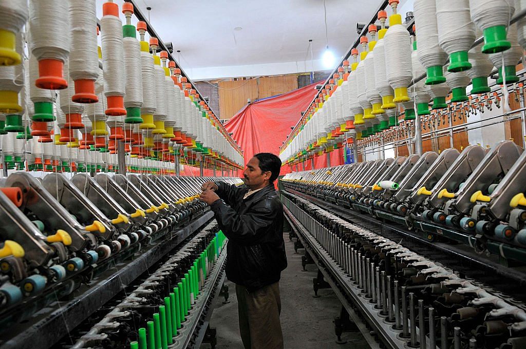 A Kashmiri labourer works inside a silk factory on the outskirts of Srinagar