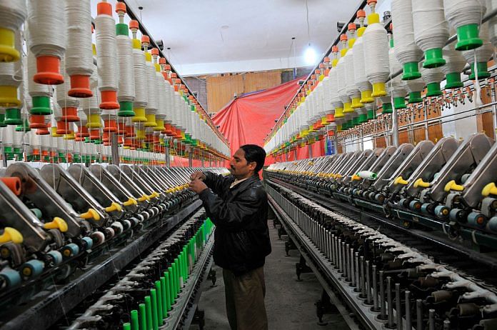 A Kashmiri labourer works inside a silk factory on the outskirts of Srinagar