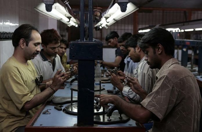 Workers polishing diamonds at a factory