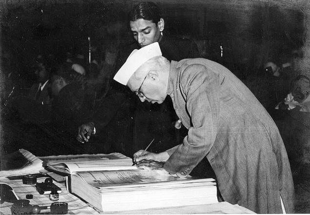 Jawaharlal Nehru signing the Indian Constitution I Wikimedia commons