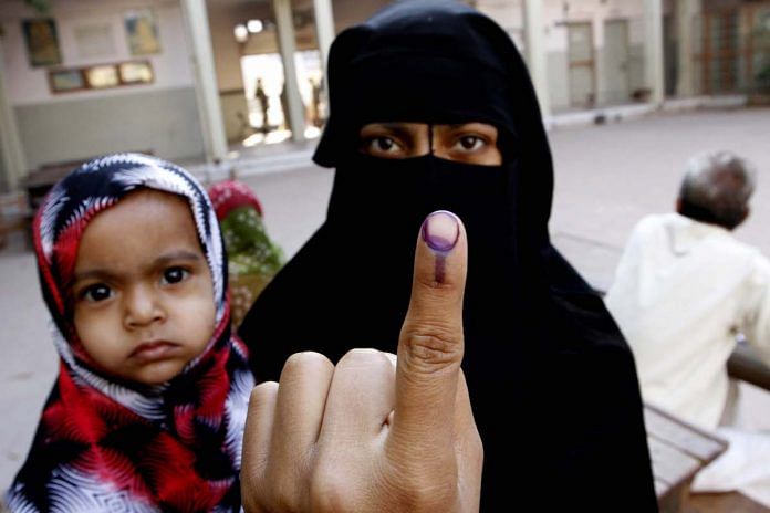 A muslim woman showing the polling mark on her finger during the 2012 polls.