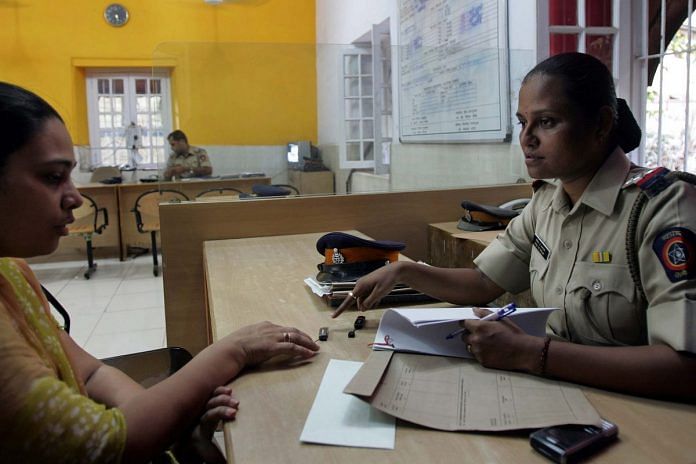 A police woman in Mumbai dealing with the registering of a crime