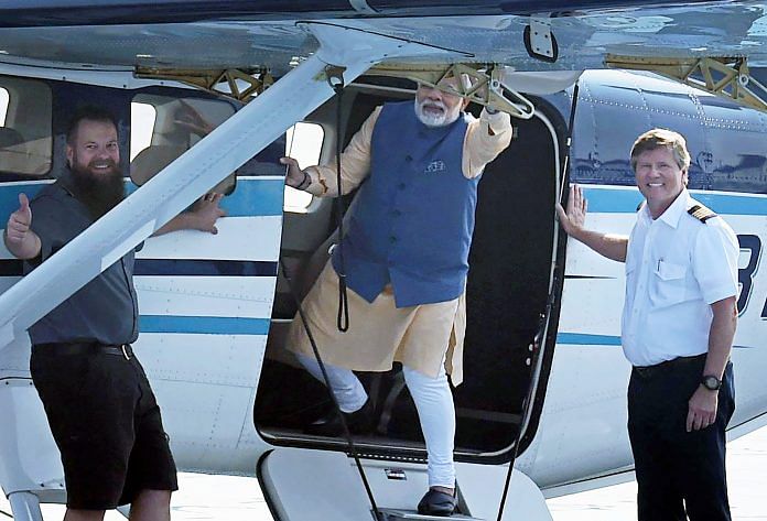 Narendra Modi waves to the crowd as he boards a seaplane on the Sabarmati river