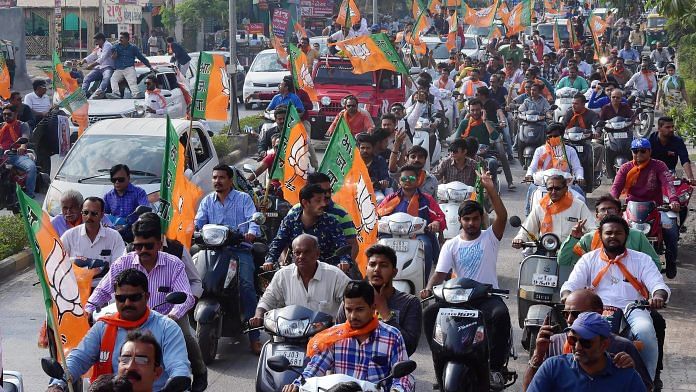 BJP supporters take part in a bike rally to celebrate the party's victory in the State Assembly election in Rajkot on Monday