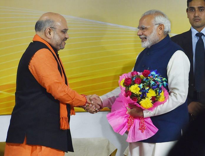 Narendra Modi being greeted by BJP President Amit Shah at a felicitation function