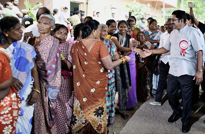 TTV Dhinakaran greeting voters at a polling booth | PTI Photo by R Senthil Kumar