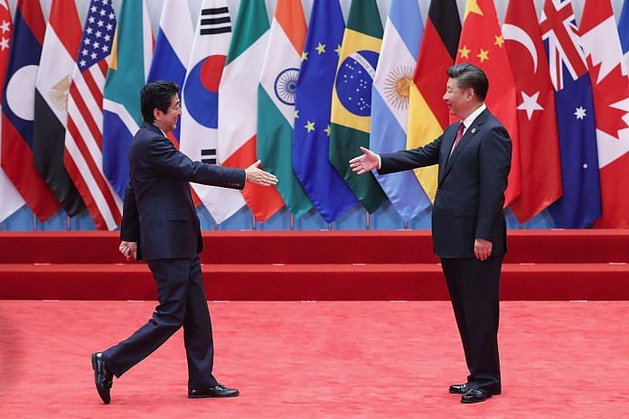 Abe and Xi shaking hands