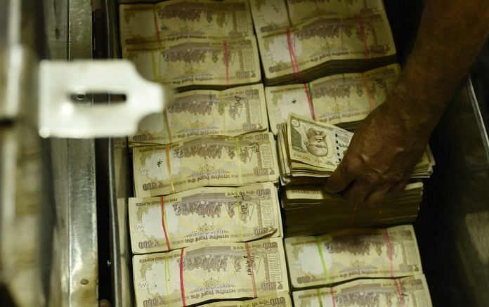 An employee stacks old currency notes at an exchange counter at Allahabad Bank, branch of Parliament Street on November 10, 2016 in New Delhi, India.