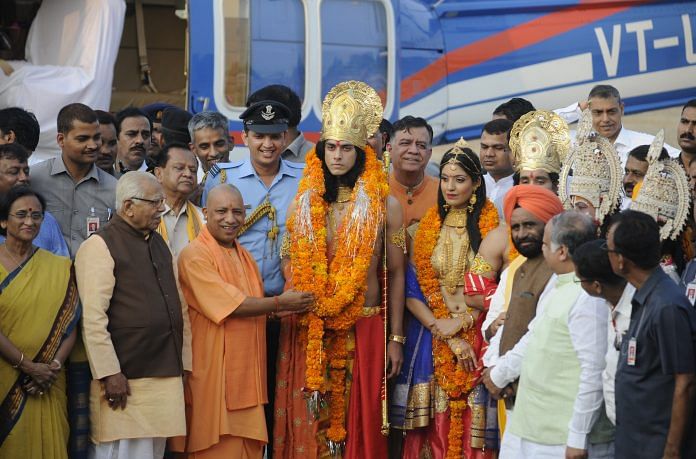 Uttar Pradesh CM Yogi Adityanath welcomes artistes dressed up as Lord Rama, Sita and Lakshman, who arrived by a chopper for Deepotsav celebrations in Ayodhya