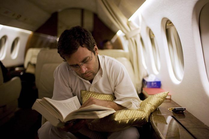 Congress President Rahul Gandhi reading on a plane