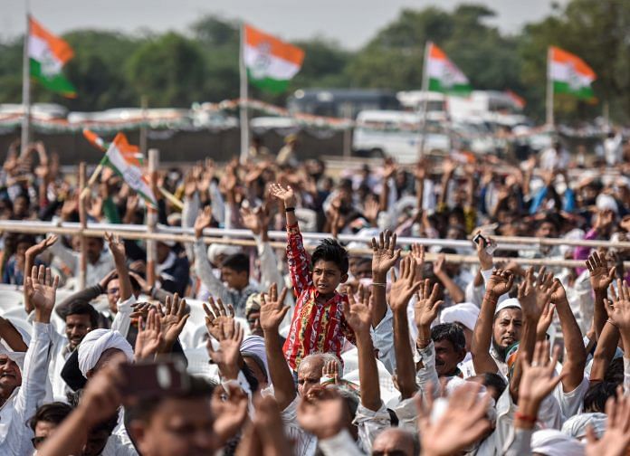 Congress supporters and workers during an election campaign rally by Rahul Gandhi