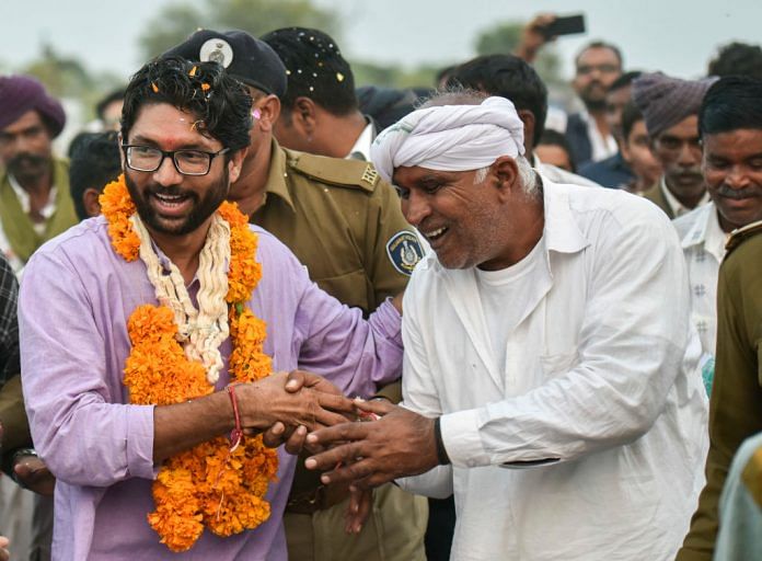 Jignesh Mevani greets people during his election campaign in Vadgam, India