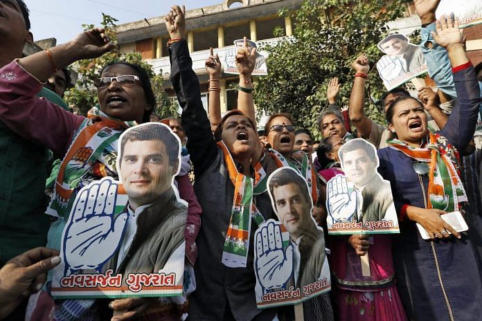 Congress party supporters holding pictures of Rahul Gandhi, in Ahmedabad.