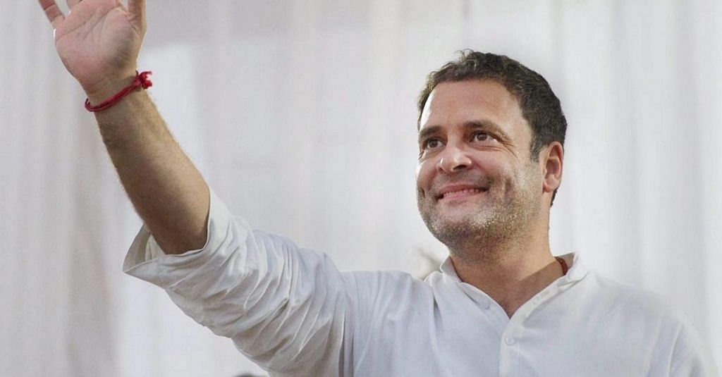 Rahul Gandhi waving to people at a rally