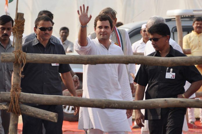 Rahul Gandhi (C) waves to the crowd after a rally in Allahabad,
