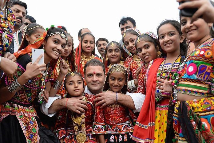 Rahul Gandhi with locals at an election meeting in Kutch district Tuesday