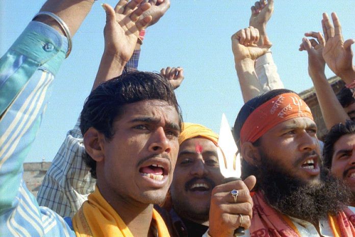 Supporters of the Ram temple construction movement display tridents in 2002 at Ayodhya.