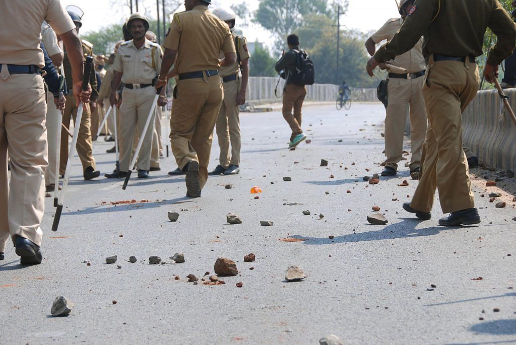 Police arrive to control the situation after an incident of violent clash at Ambedkar Nagar