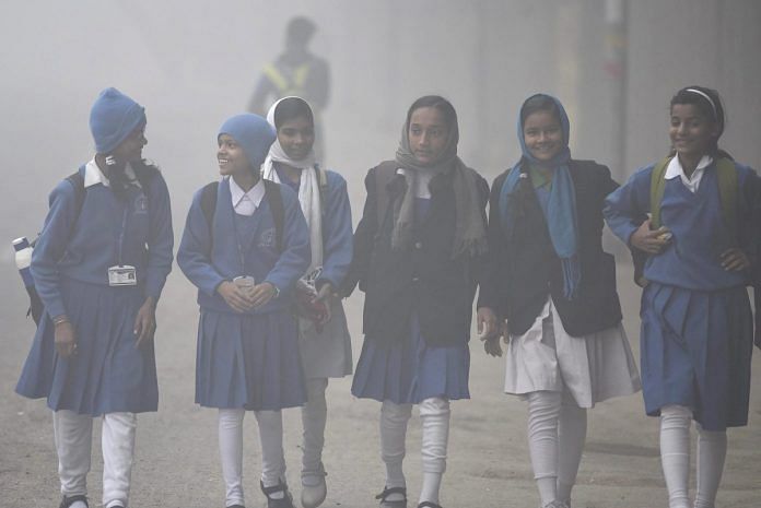 Children going to school despite heavy fog