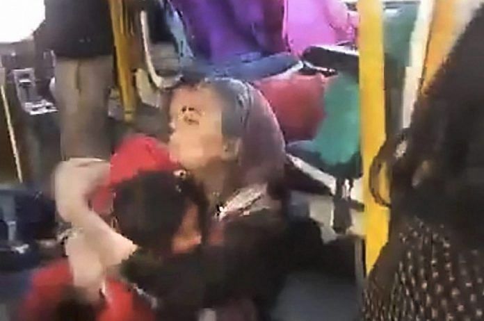 A woman hugs a child crouched on the floor of the GD Goenka World School bus, as a mob protesting against the film Padmaavat threw stones at their bus in Gurugram on Wednesday.