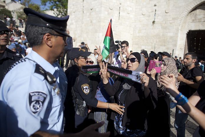 Israeli policemen detain Palestinians in Israel