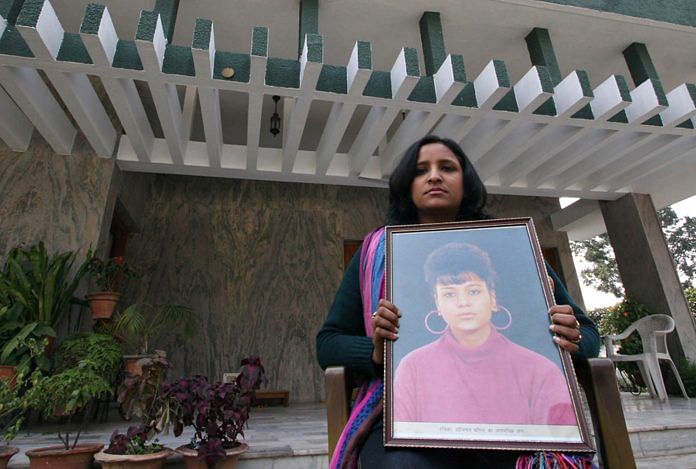 Aradhna Gupta, who witnessed the assault on her best friend Ruchika Girhotra in 1990, holds a portrait of her