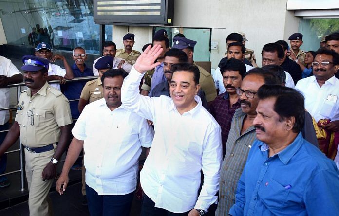 Actor Kamal Haasan waves at his supporters on his arrival at the airport in Madurai