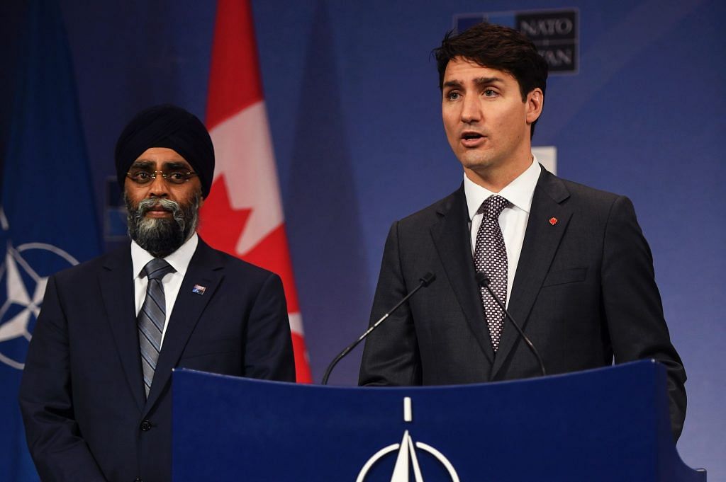 Canadian Prime Minister Justin Trudeau flanked by Canadian Minister of Defence Harjit Sajjan