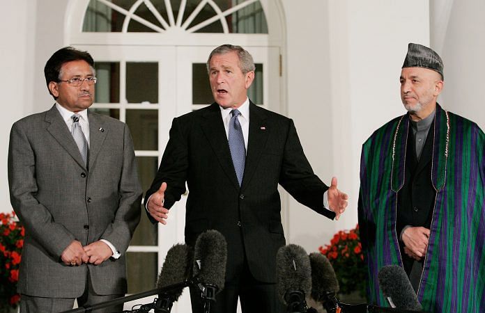 George W. Bush delivers remarks while flanked by Hamid Karzai and Pervez Musharraf in 2006