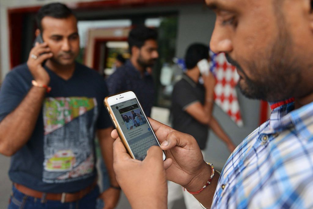 Indian men use their mobile phones (representational image) | NARINDER NANU/AFP/Getty Images