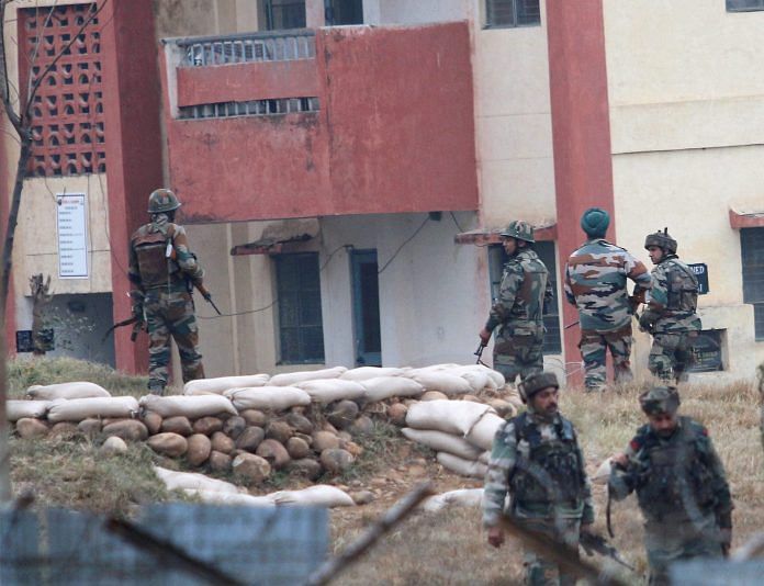Security personnel take position around the army family quarters at Sunjuwan Military Station during the terrorist attack in Jammu