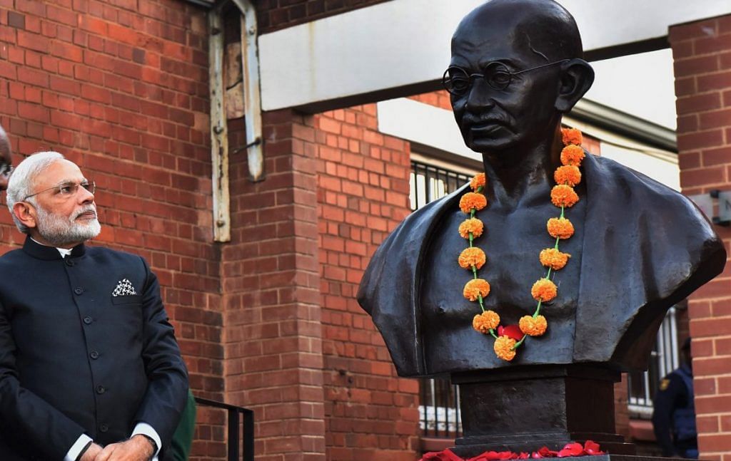 Narendra Modi with a statue of Mahatma Gandhi