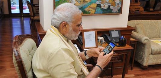 Narednra Modi holding a phone
