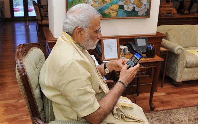 Narednra Modi holding a phone