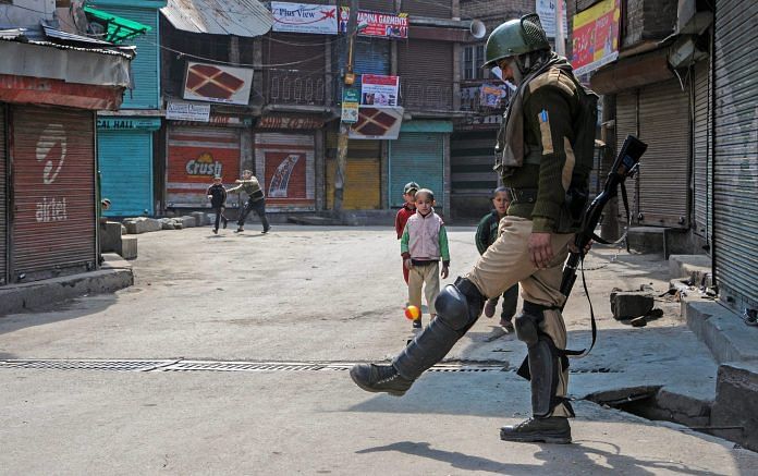 A security person passes the ball to children, Srinagar | PTI
