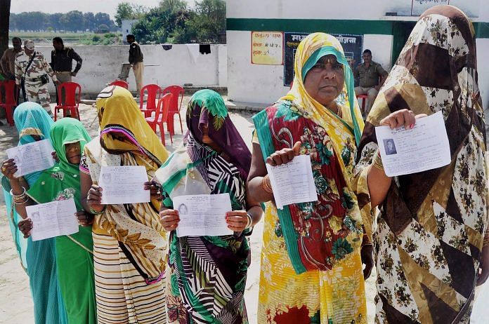 Voters at a polling booth for Phulpur bypoll elections