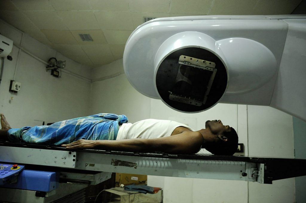 A cancer patient receives radiation treatment at a government cancer hospital