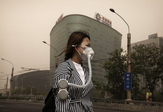 A Chinese woman wears a mask