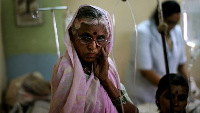 A woman looks on over her husband's sick bed in a local hospital.